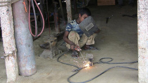 Child Labor - Welding in a Garage by uncultured at Flickr